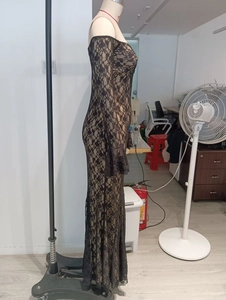 Detailed view of black floral lace fabric on an off-shoulder bodycon evening dress