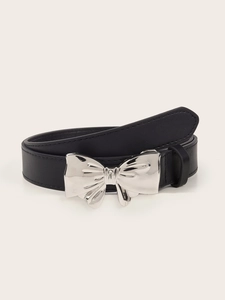 Close-up of black leather belt featuring a polished silver bow-knot buckle detail