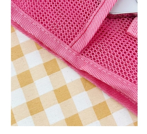 Detail of pink mesh storage bag showing neat stitching and breathable polyester fabric