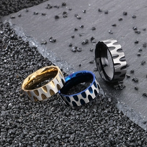 Macro detail of men's titanium steel rings with flame wave relief in gold, blue, and black