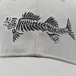 Detailed macro view of 3D fish bone embroidery on a grey twill cotton baseball cap
