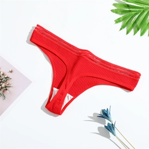 Red ribbed cotton thong for women on white background with decorative flowers