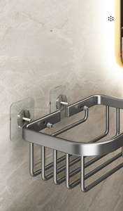 Detail of grey aluminum bathroom shelf with punch-free adhesive mounting on marble wall