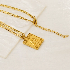Bohemian gold plated figaro necklace with engraved rectangular pendant featuring mystic motifs