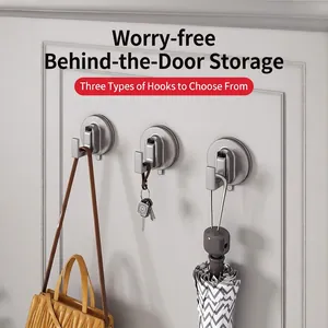 Three-piece silver vacuum suction cup wall hooks holding bag and keys in home setting