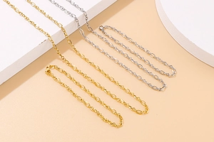 Detail view of minimalist gold and silver oval link chain necklaces with lobster clasps
