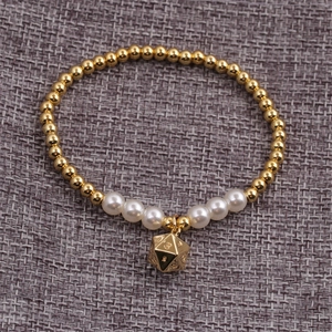 Elastic beaded couple bracelet featuring gold metal beads, white pearls, and a d20 dice charm