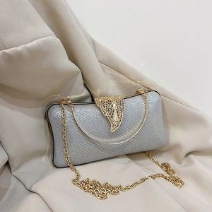 Silver glitter clutch bag with gold leaf clasp and removable gold chain strap