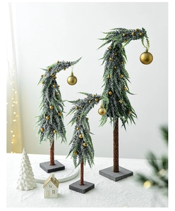 Three-piece set of mini flocked Christmas trees with gold ornaments on a grey base