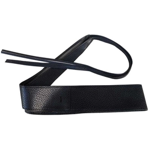 Detail of black wide waist belt with lychee texture and wrap-around tie closure