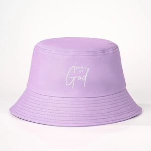 Detailed close-up of CHILD OF God embroidery on a light purple cotton bucket hat