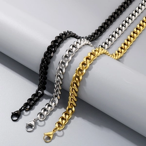 Detailed view of three stainless steel curb chains in black, silver and gold finishes
