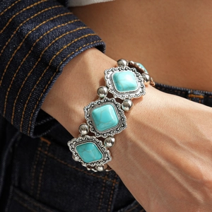Close-up of bohemian stretch bracelet featuring blue turquoise stones and vintage silver patterns