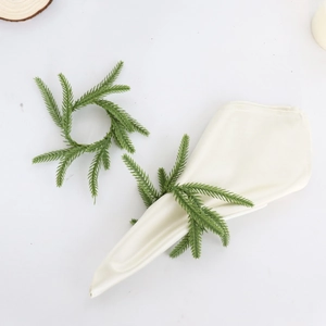Norfolk pine artificial greenery napkin ring with natural needles on white linen