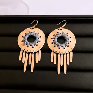Bohemian gold hollow disc earrings with blue woven pattern and metal leaf tassels