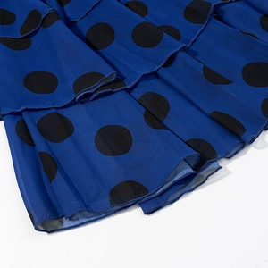 Detail view of tiered chiffon hemline with navy blue and black polka dot pattern