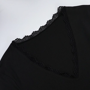 Detail shot of the V-neckline with delicate black lace trim on a minimalist autumn top
