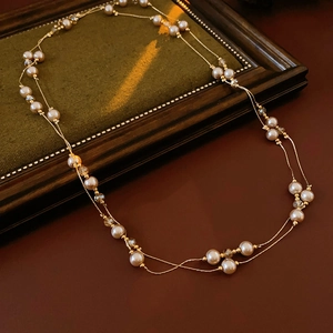 Close-up of double-layer necklace with white pearls and champagne crystal beads