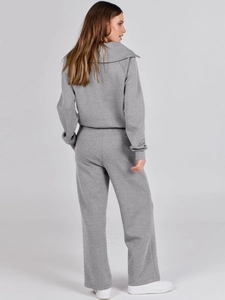 Detail view of the back of a grey zip-up hoodie and wide-leg sweatpants set for women