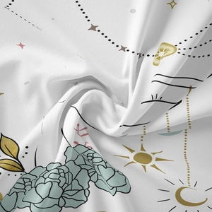 Close-up of bohemian fabric showing detailed sun and moon prints on white texture