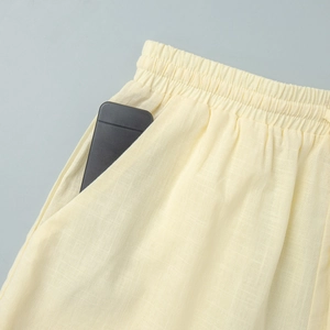 Détail du short en coton beige clair avec taille élastique à cordon et poches latérales