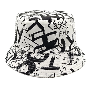 White bucket hat with black graffiti and letter print, versatile summer sun protection style