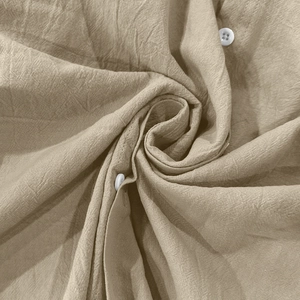 Macro shot of breathable khaki linen shirt fabric with detailed texture and button