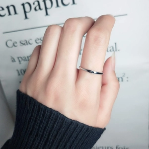 Minimalist stainless steel heart ring with black enamel drop detail on silver band