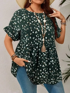 Detail of dark green short-sleeve top with abstract print and ruffle sleeves on model