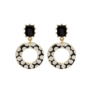 Detailed view of geometric black rectangle studs with white polka dot charms on gold frames