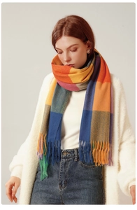 Detailed close-up of a colorful checkered scarf with long fringe tassels on the ends