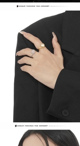 Close-up of S925 sterling silver opal rings on hand with irregular texture detail