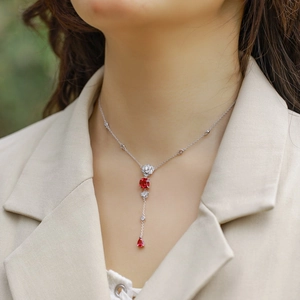 Elegant silver Y-shaped necklace with pear-cut red gems and sparkling accents for women