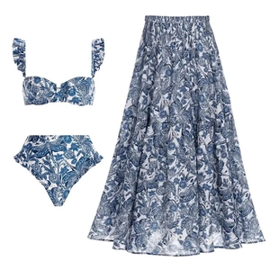 Three-piece blue and white floral swimsuit set with ruffled bikini and layered maxi skirt