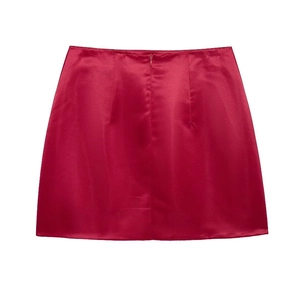 Detailed view of red A-line satin mini skirt with smooth texture and central seam