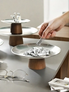 Detailed shot of placing coffee candy on a French style metal tier tray with wooden base