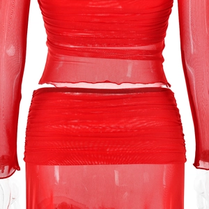 Close-up of red sheer mesh two-piece set featuring pleated texture and long sleeves