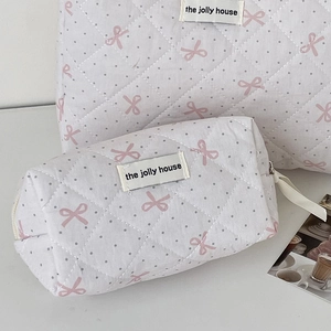 Quilted bow makeup bag set including large pouch and small cylinder in pink polka dots