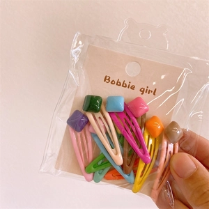 Detail of 10-piece mini resin bear and heart hair clips set in colorful packaging