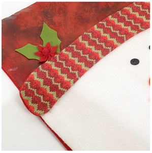 Close-up of Christmas chair cover with red fabric, white fleece, and knit decorative band