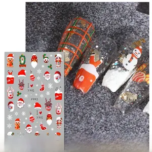 Detail of Christmas nail stickers with Santa, elk and gingerbread man on clear nails