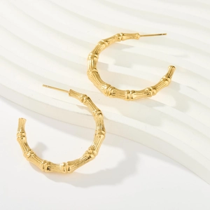 18K gold C-hoop earrings featuring elegant bamboo texture in a minimalist geometric design