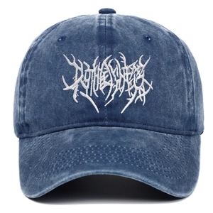 Detail of vintage washed denim baseball cap with heavy metal style white embroidery