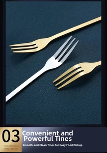 Close-up of gold and silver stainless steel leaf dessert forks on dark leather background