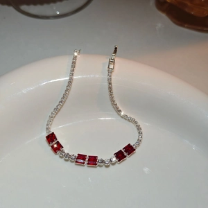 Detail of silver bracelet featuring rectangular red zircon and sparkling crystal pave