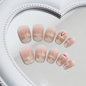 Christmas press-on nails featuring pink cat-eye gradient with Santa and reindeer patterns