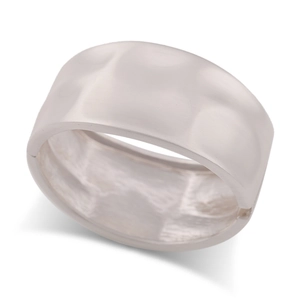 Detailed view of wide hammered silver metal bangle with a hinged opening mechanism