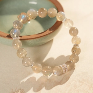 Macro shot of natural gray labradorite beads bracelet with blue sheen and silver spacers