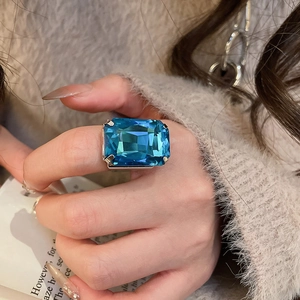 Close-up of a large rectangular aquamarine gemstone set in a silver cocktail ring