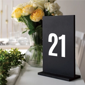 Close-up of matte black 2-inch number 21 table sign with vinyl sticker for weddings